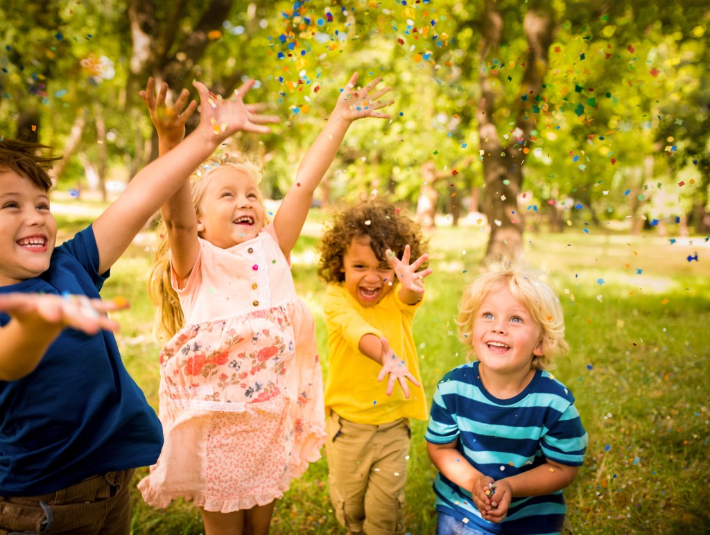 Happy-child-friends-having-fun-with-confetti-in-a-park-000062321348_XXXLarge